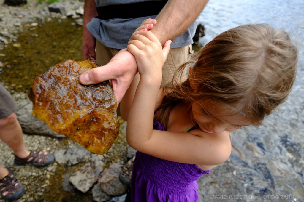 A man holds out a piece of rock found in the Clearwater River.