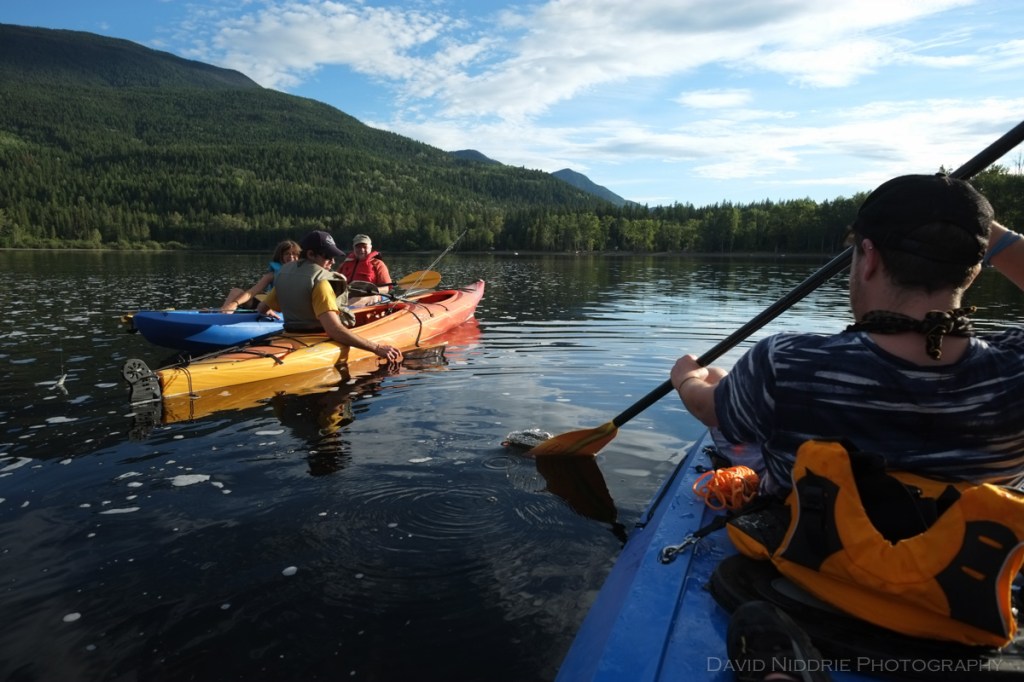 Kayakers meet up on Mahood Lake, BC.