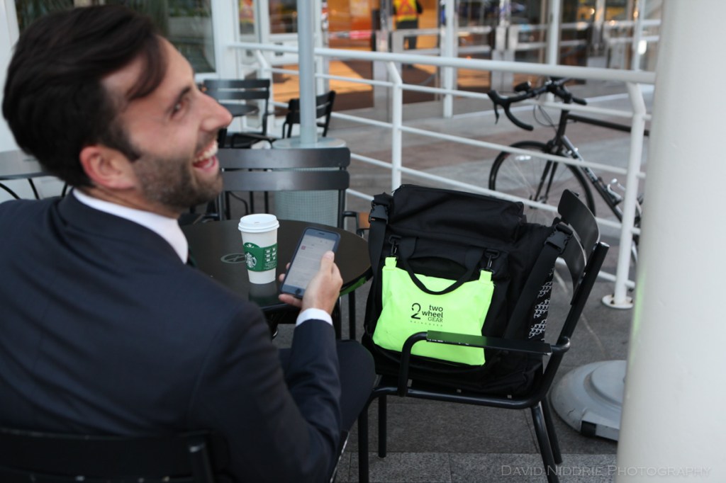 A man poses on a Vancouver street with Two Wheel Gear bicycle pannier.