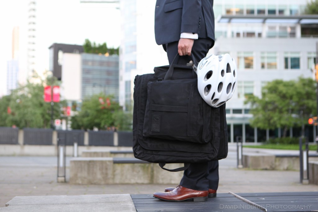 A man poses on a Vancouver street with Two Wheel Gear bicycle pannier.
