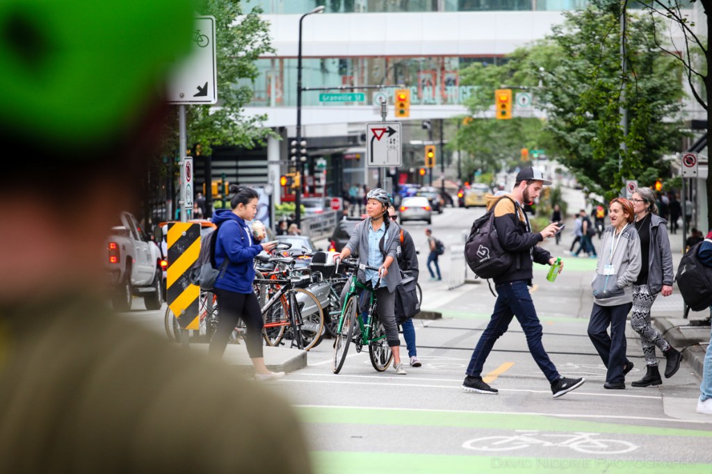 A woman poses on a Vancouver street with Two Wheel Gear bicycle pannier.