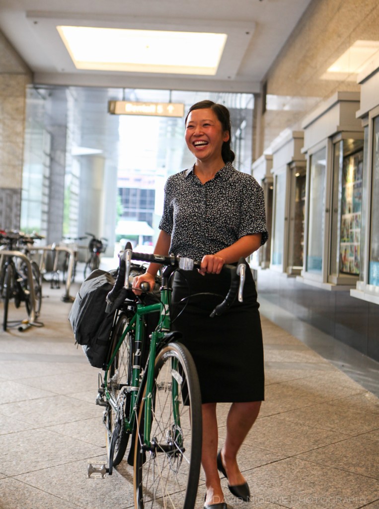 A woman poses on a Vancouver street with Two Wheel Gear bicycle pannier.