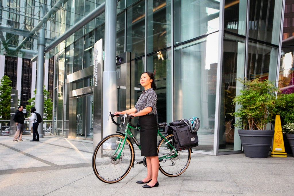 A woman poses on a Vancouver street with Two Wheel Gear bicycle pannier.