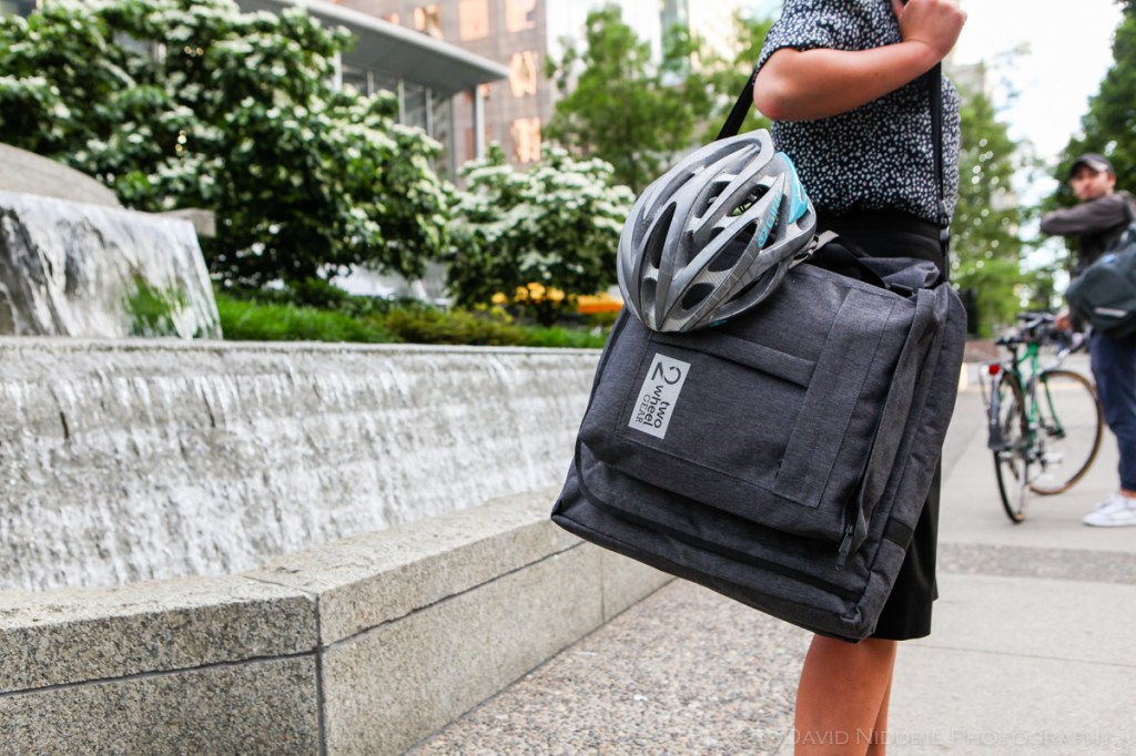 A woman poses on a Vancouver street with Two Wheel Gear bicycle pannier.