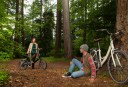 A couple meet in the forest to ride their e-bikes together